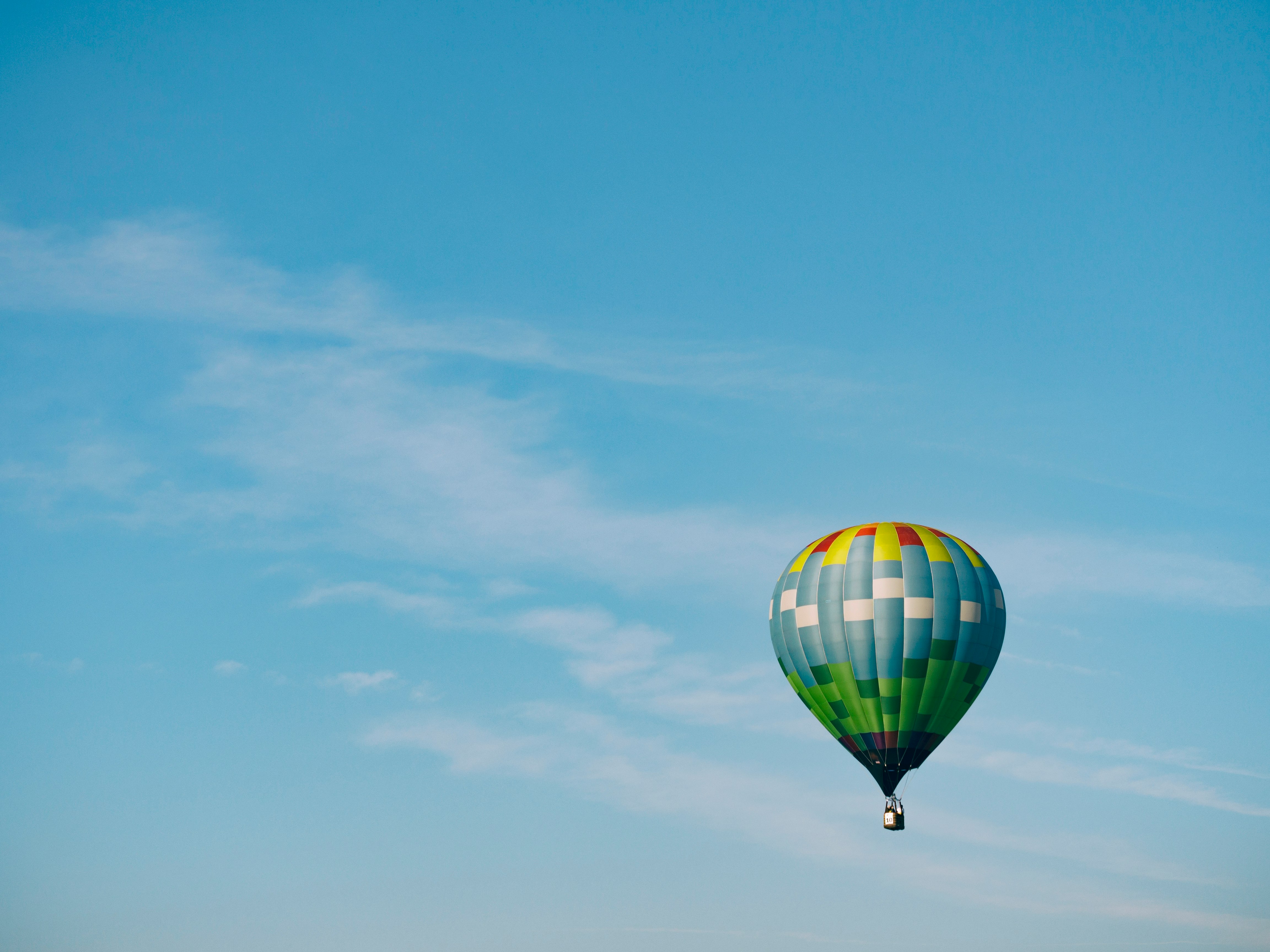 multi-colored hot air balloon flying on sky